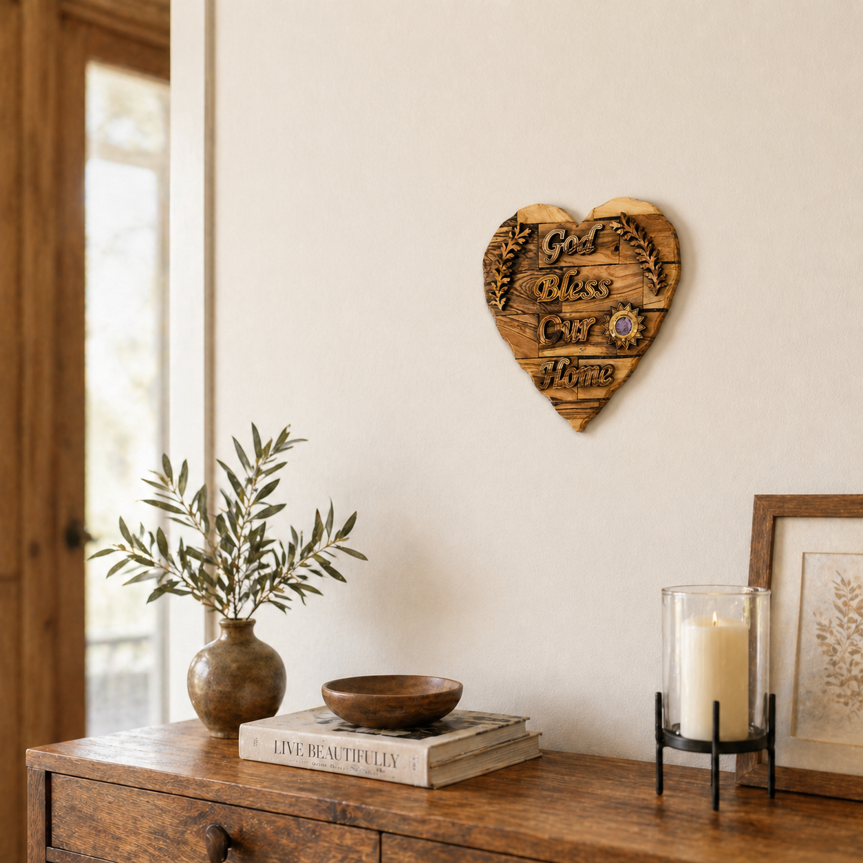 Olive wood God Bless Our Home heart plaque lifestyle scene with olive branch and candle, Bethlehem