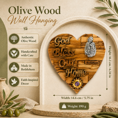 Olive wood Holy Family heart plaque displayed against archway with olive branches, Bethlehem