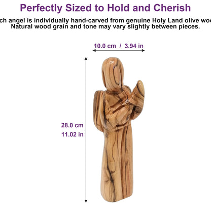 Compact olive wood angel from Bethlehem resting in a human palm, showing its perfectly portable, gift-ready size.