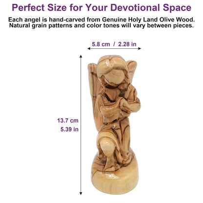 Holy Land olive wood angel shown next to a hand for scale, highlighting its 5.4-inch hand-carved craftsmanship.