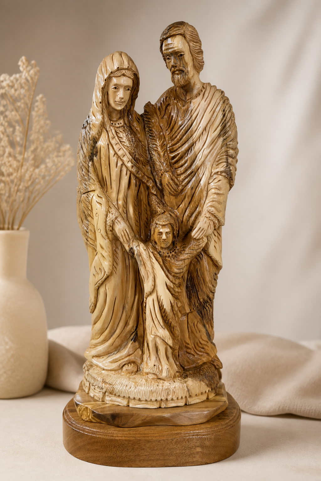 Holy Family carving with Mary Joseph and child Jesus in a warm display setting