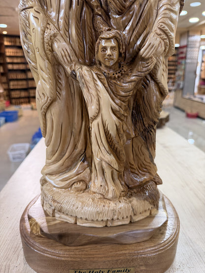Detailed view of child Jesus holding Mary and Joseph hands in the olive wood carving