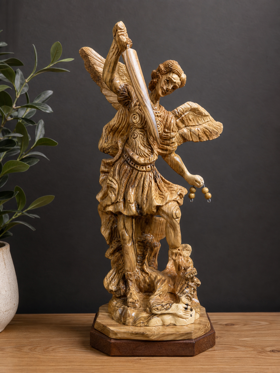 Tall St. Michael Archangel carving displayed with a dark neutral background