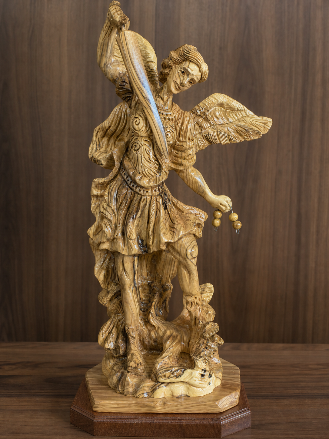 Olive wood St. Michael statue showing the sword, armor and broad carved wings