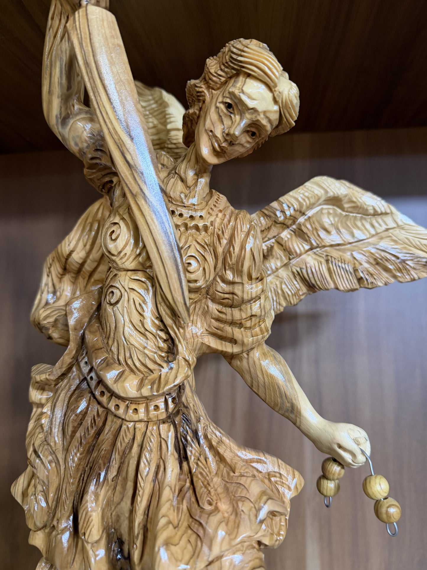 Rear wing view of the large olive wood St. Michael carving
