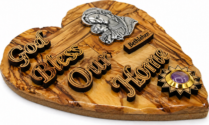 Side angle of olive wood God Bless Our Home heart plaque from Bethlehem showing 2 cm depth and grain detail
