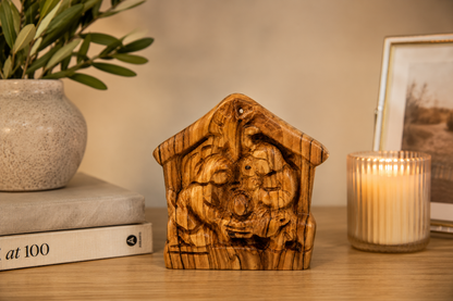 Olive Wood Holy Family on a wooden desk, hand carved olive wood from Bethlehem