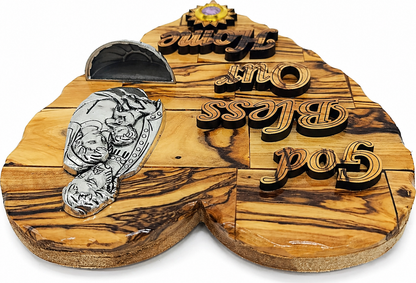 Olive wood Holy Family heart plaque from Bethlehem in lifestyle setting with Joseph icon and holy water stoup