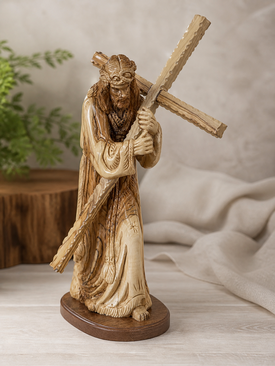 Jesus carrying the cross sculpture displayed in a calm neutral home setting