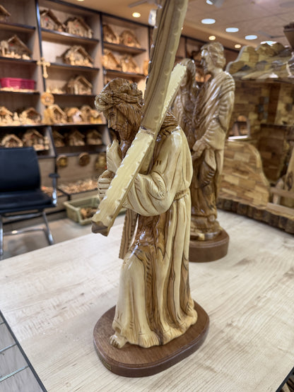 Side view showing the robe and cross of the olive wood Jesus carving