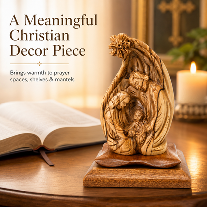 Olive wood Nativity scene beside an open Bible and a lit candle in a prayer space