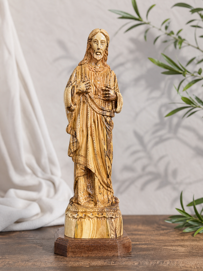Bethlehem Sacred Heart carving shown against a soft fabric and olive branch setting