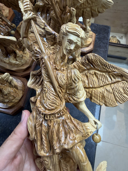 Real close photograph of the St. Michael statue face, armor, spear and carved olive wood grain