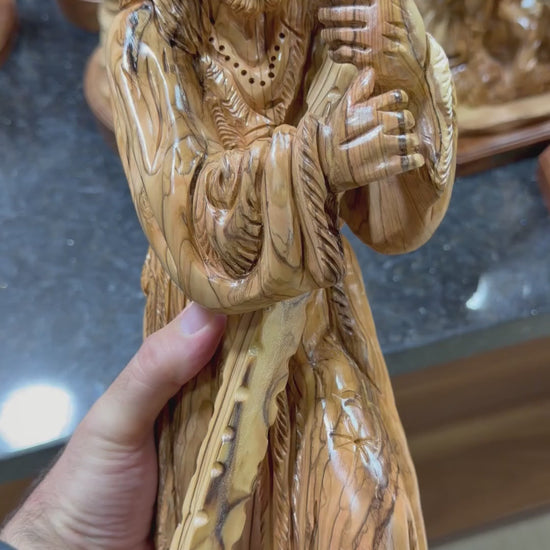 Olive wood Jesus carrying the cross statue from Bethlehem shown in a short workshop video