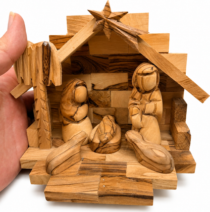Wooden Nativity Stable on a holiday table, hand carved olive wood Bethlehem