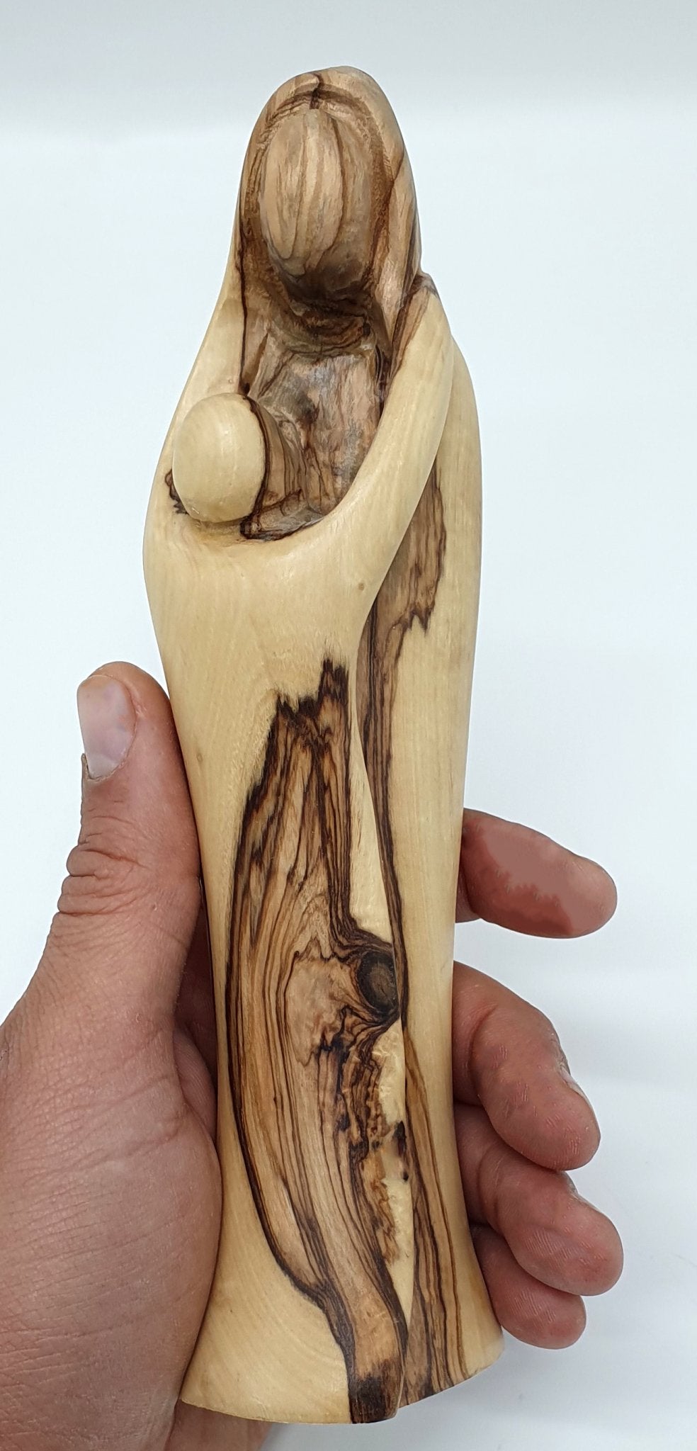 Experience the sublime beauty and intricate detailing of our Mary and Baby Jesus Handcrafted Olivewood Statue by Zuluf - Zuluf